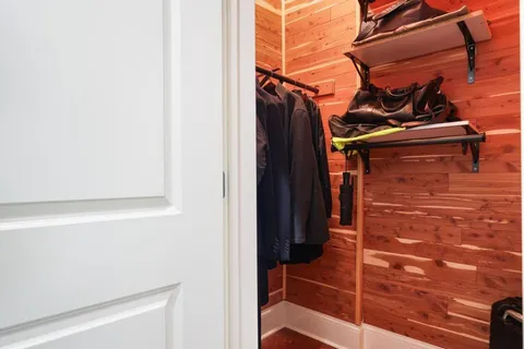 a view of walk in closet with clothes