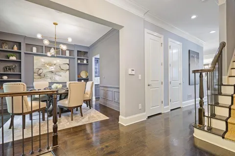 a view of a a dining room with furniture window and wooden floor