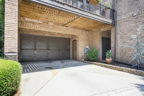a front view of a brick house with a garage