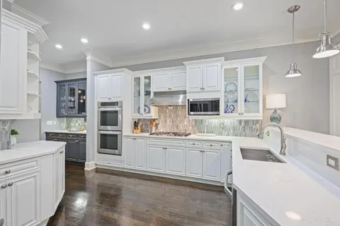 a kitchen with a sink stove and cabinets