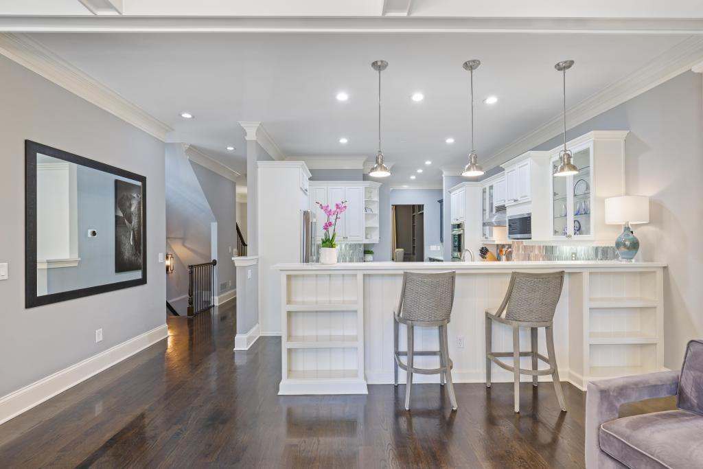 3601 Habersham Road Northwest Atlanta, GA 30305 - Photo 10 of 34 a kitchen with stainless steel appliances kitchen island granite countertop a refrigerator a stove and white cabinets with wooden floor