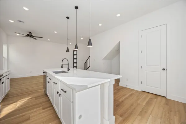 a spacious bathroom with a sink and a mirror