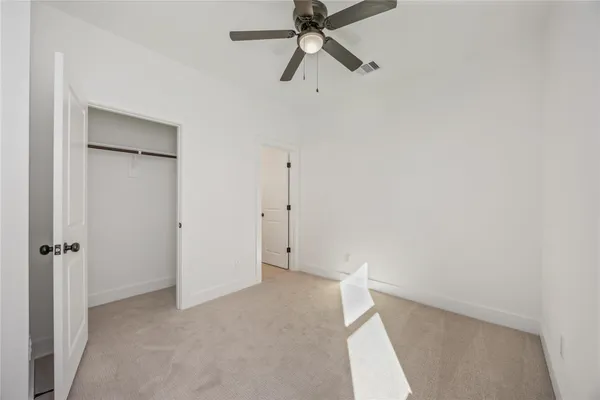 a view of a room with window and ceiling fan
