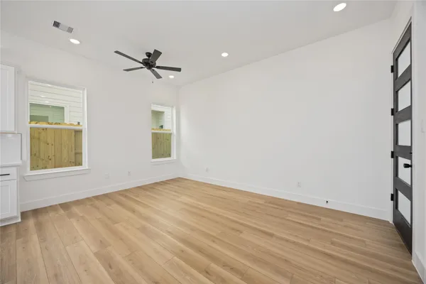 wooden floor in an empty room with a window