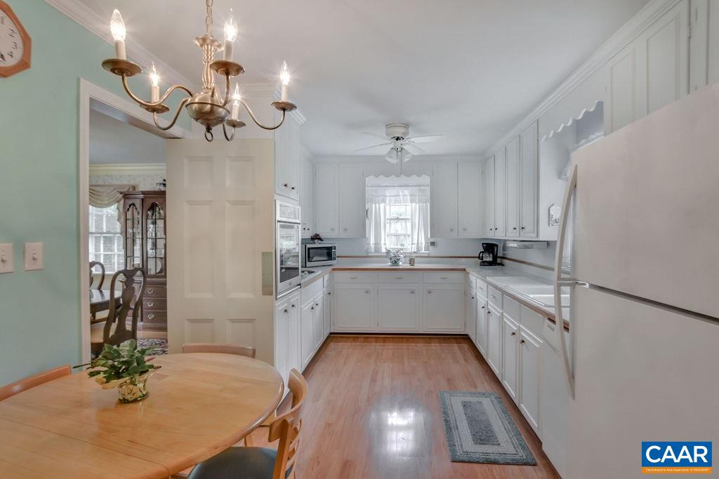 103 Surrey Road Charlottesville, VA 22901 - Photo 12 of 28 a kitchen with white cabinets and white appliances