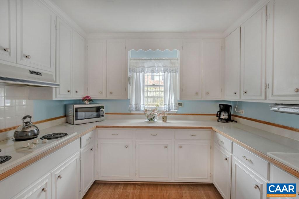 103 Surrey Road Charlottesville, VA 22901 - Photo 13 of 28 a kitchen with granite countertop white cabinets white appliances and sink