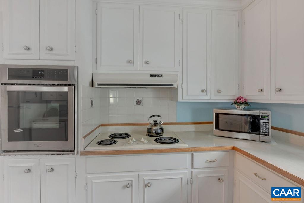 103 Surrey Road Charlottesville, VA 22901 - Photo 14 of 28 a kitchen with white cabinets and white appliances
