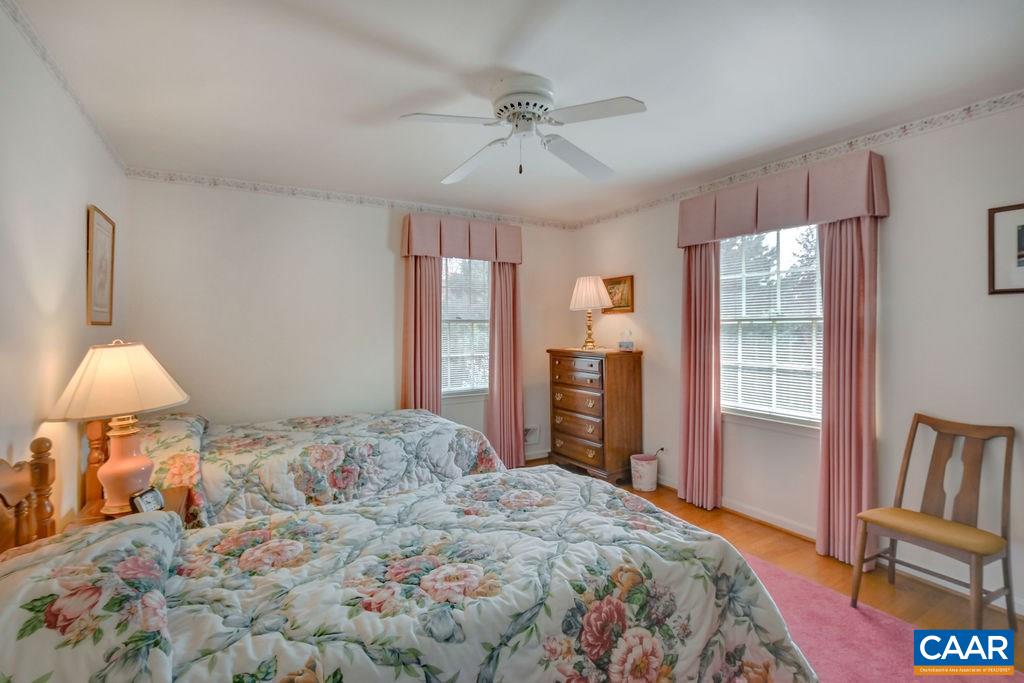 103 Surrey Road Charlottesville, VA 22901 - Photo 18 of 28 a bedroom with a large bed and a chandelier