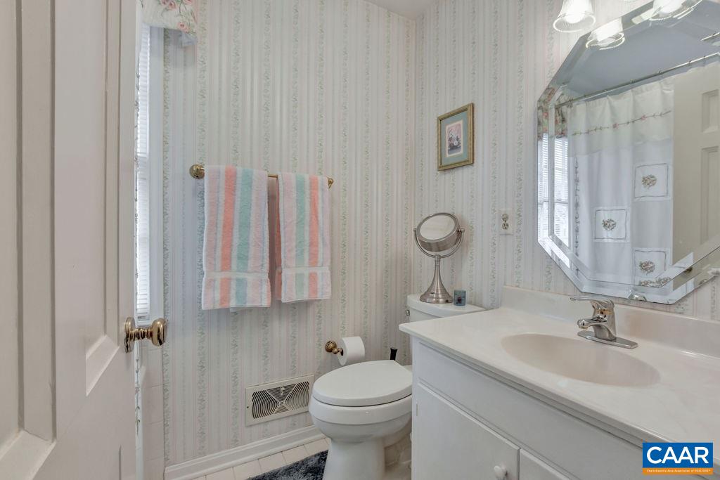 103 Surrey Road Charlottesville, VA 22901 - Photo 20 of 28 a bathroom with a toilet sink and mirror