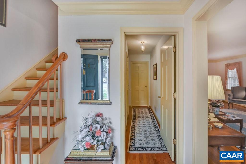 103 Surrey Road Charlottesville, VA 22901 - Photo 3 of 28 a view of a hallway to a livingroom with furniture and staircase