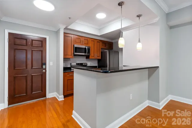 a kitchen with stainless steel appliances a refrigerator and a stove