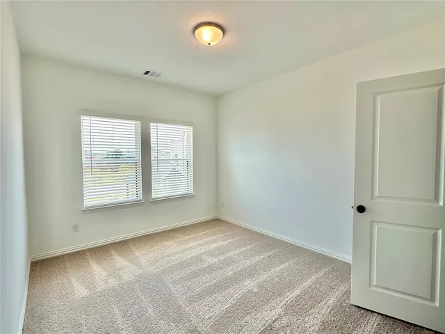 a bathroom with a granite countertop sink a toilet a mirror and shower