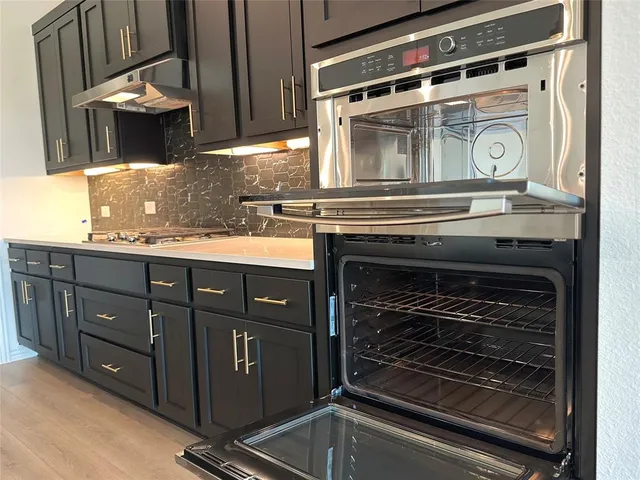 a kitchen with granite countertop a stove oven and sink