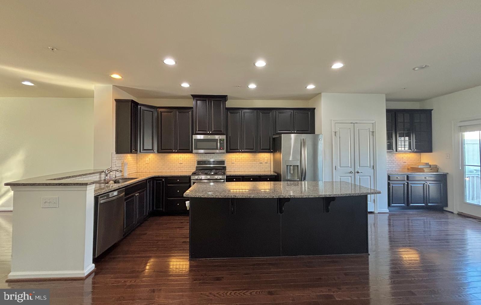 225 Quarry Point Road Malvern, PA 19355 - Photo 3 of 19 a kitchen with kitchen island granite countertop a sink and a stove top oven