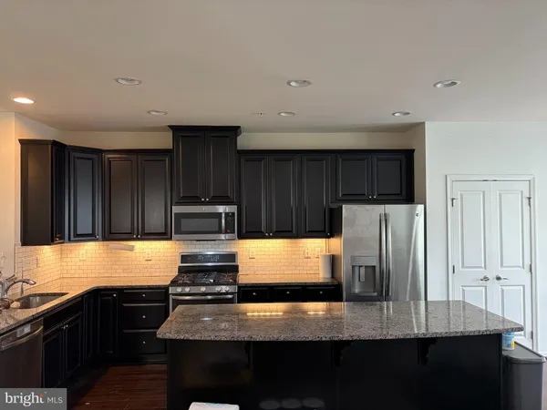 a kitchen with refrigerator and stove