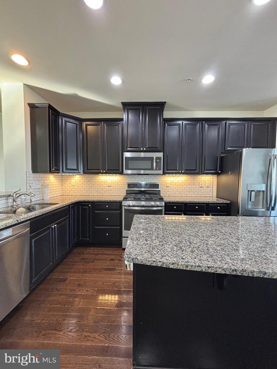225 Quarry Point Road Malvern, PA 19355 - Photo 5 of 19 a kitchen with stainless steel appliances granite countertop a sink stove and cabinets