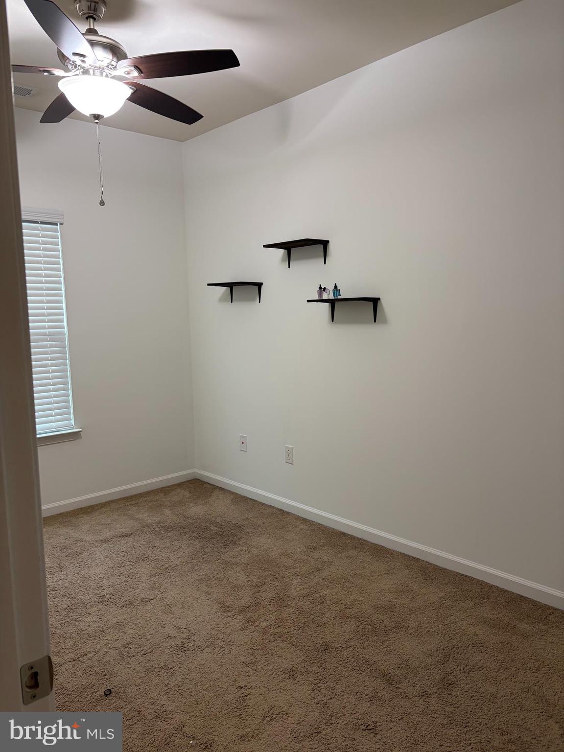 225 Quarry Point Road Malvern, PA 19355 - Photo 7 of 19 an empty room with a window and a ceiling fan