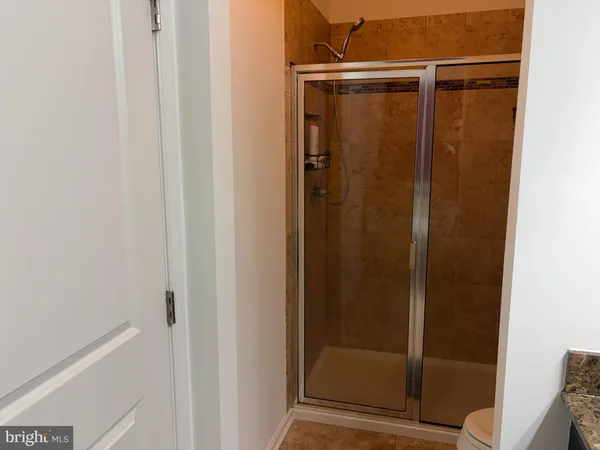 a bathroom with a glass door shower