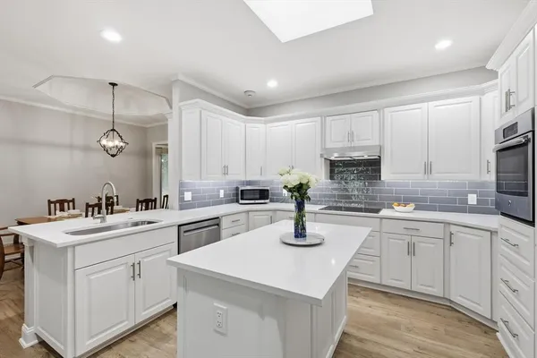 a kitchen with a sink stove and cabinets