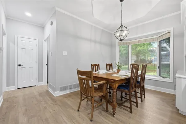 a view of a dining room with furniture window and wooden floor