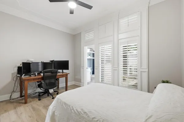 a bedroom with a bed and a desk