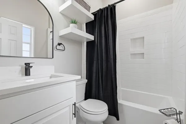 a bathroom with a sink a toilet and a bathtub