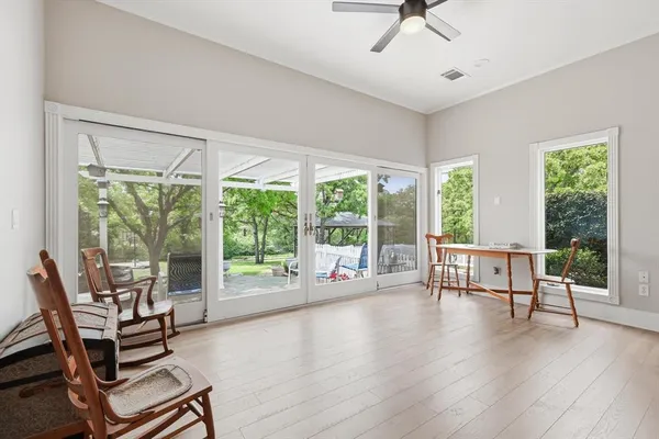 a living room with furniture and a large window with wooden floor