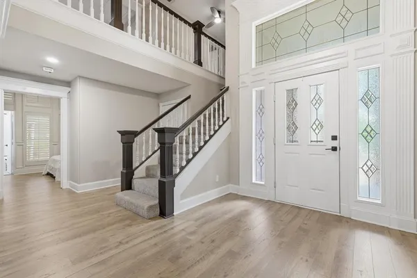 a view of an entryway with wooden floor