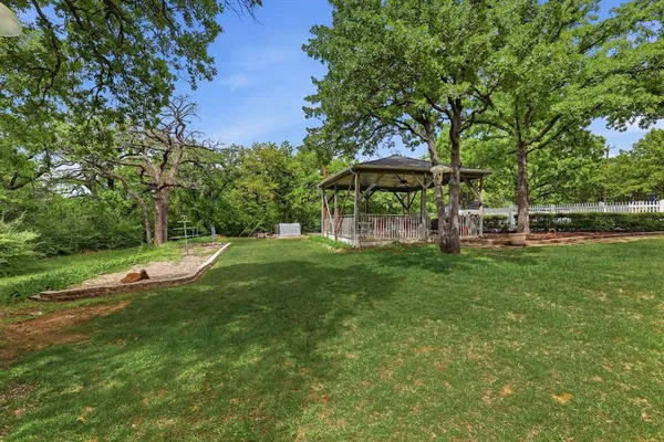 a view of a park with large trees