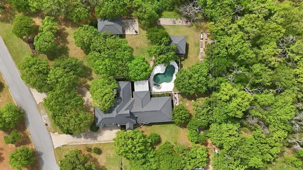 an aerial view of a house with a yard and garden