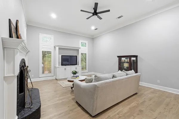 a living room with furniture a fireplace and a flat screen tv