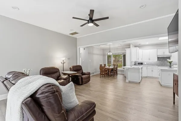 a living room with furniture and kitchen view