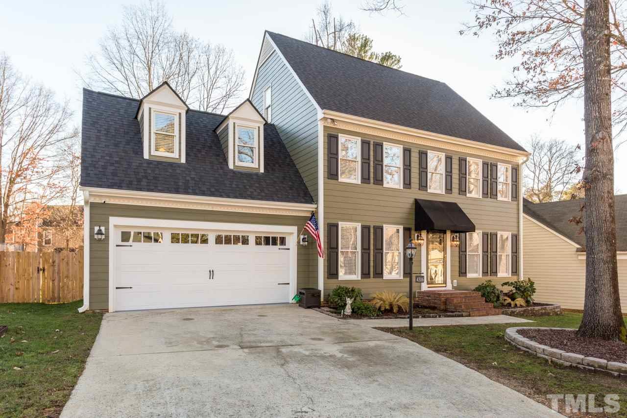4316 Birmingham Way Raleigh, NC 27604 - Photo 1 of 25 a front view of a building with a garden and trees