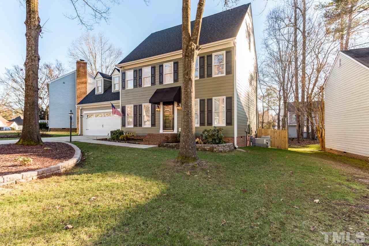 4316 Birmingham Way Raleigh, NC 27604 - Photo 2 of 25 a front view of a house with a garden and tree