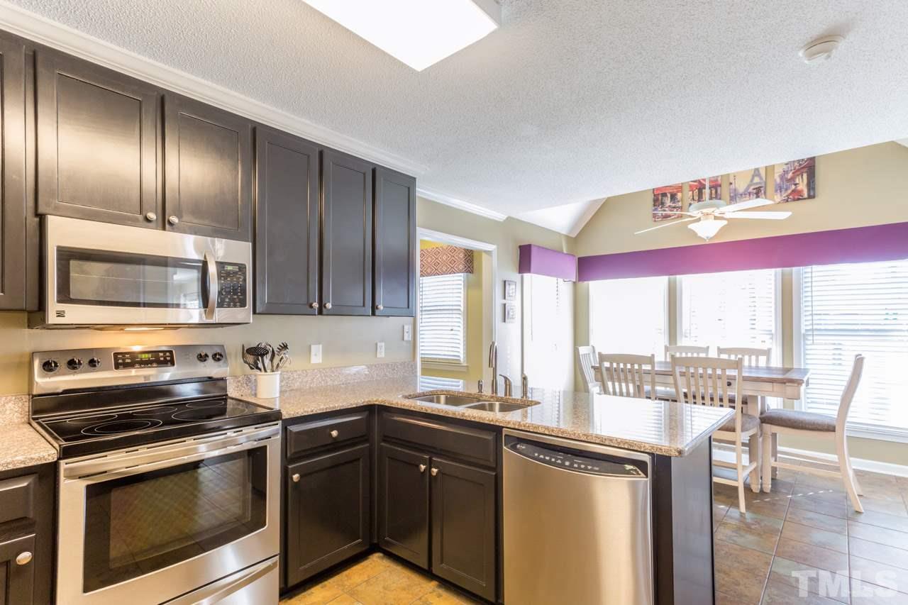 4316 Birmingham Way Raleigh, NC 27604 - Photo 11 of 25 a kitchen with a sink stove and microwave