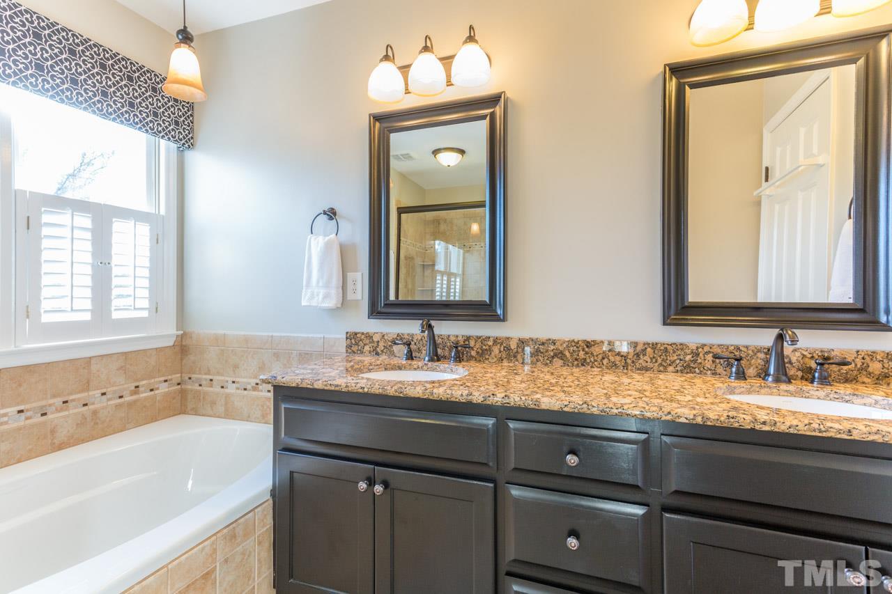 4316 Birmingham Way Raleigh, NC 27604 - Photo 16 of 25 a bathroom with a sink and a mirror