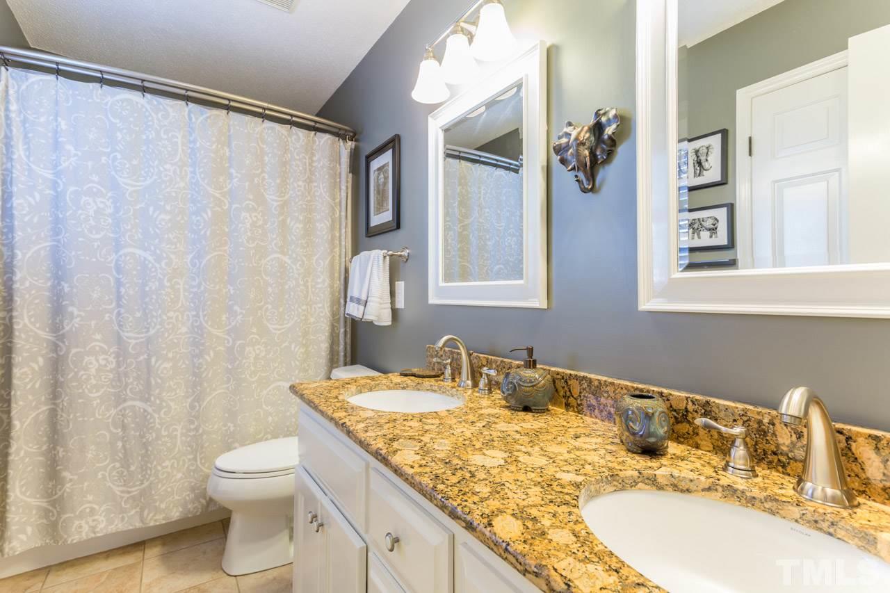 4316 Birmingham Way Raleigh, NC 27604 - Photo 19 of 25 a bathroom with a granite countertop sink toilet and shower