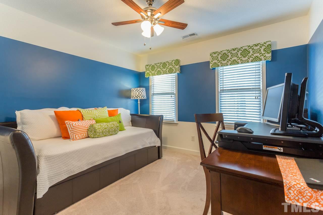 4316 Birmingham Way Raleigh, NC 27604 - Photo 20 of 25 a bedroom with a bed and a flat screen tv