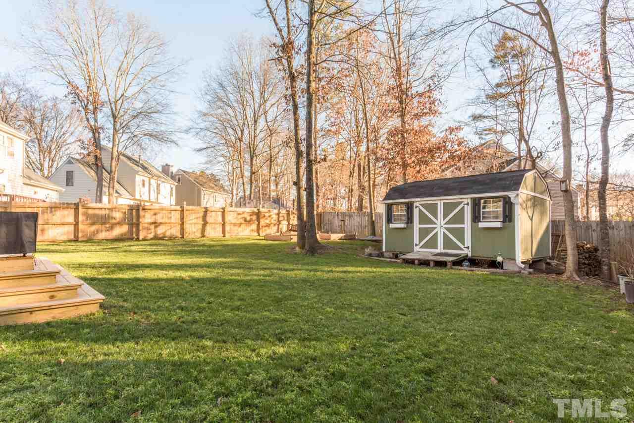 4316 Birmingham Way Raleigh, NC 27604 - Photo 24 of 25 a view of a house with a big yard and large trees