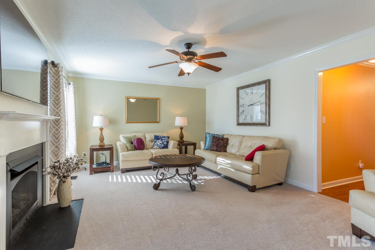 4316 Birmingham Way Raleigh, NC 27604 - Photo 7 of 25 a living room with furniture and a fireplace