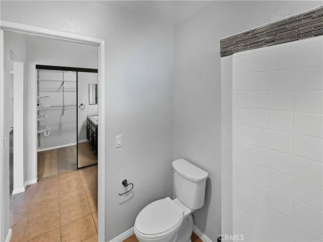a white toilet sitting next to a bathroom sink