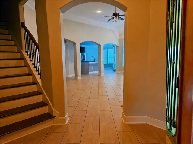 a view of a hallway with wooden floor and staircase