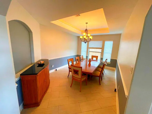 a dining room with furniture and chandelier
