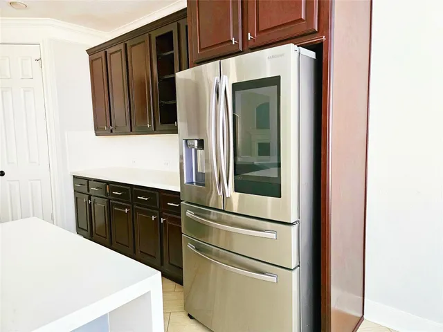 a kitchen with a refrigerator and cabinets