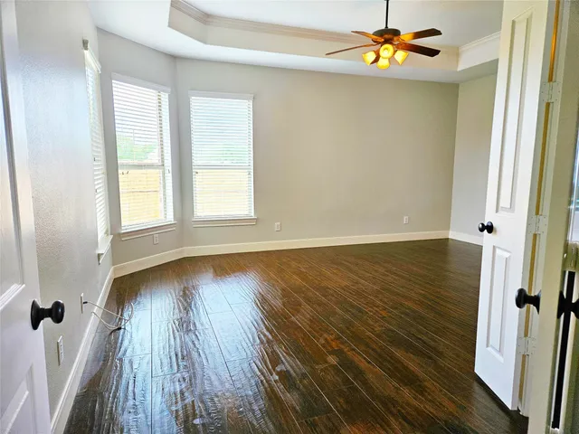 wooden floor in an empty room with a window