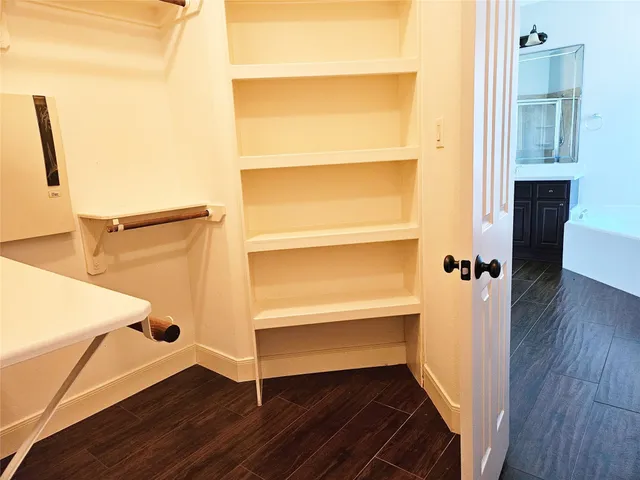 a view of walk in closet with empty racks