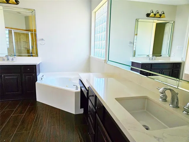 a bathroom with a bathtub and a sink