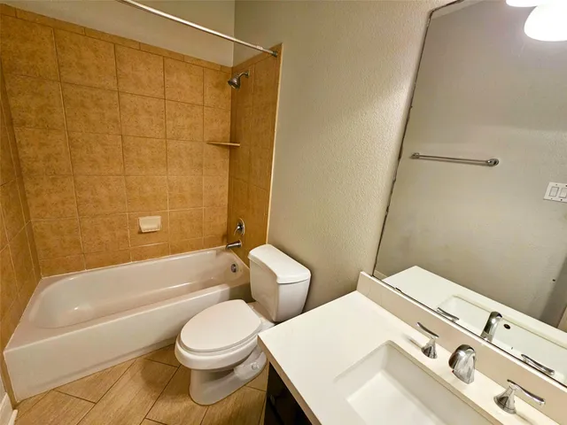 a bathroom with a sink a toilet and bathtub