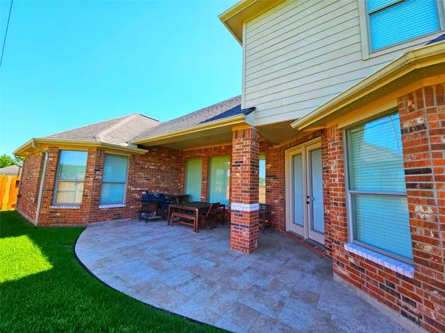 a view of a house with backyard porch and sitting area