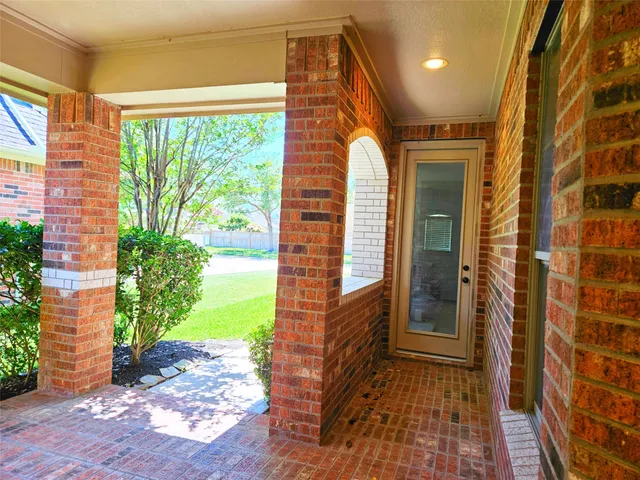 a view of a brick house with a backyard